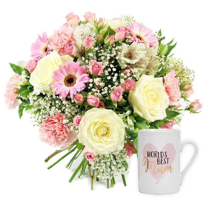 This carefully styled studio photograph presents a loving mum-themed gift set, ideal for a home in Golders Green or the surrounding leafy streets. The composition is simple yet elegant, set against a clean white backdrop that allows every colour and texture to stand out. On the left, a generous, round bouquet is gathered in a hand-tied style, its stems visible and neatly bound at the base. At its core sit several large cream-coloured roses in full bloom, their petals unfolding in smooth, symmetrical spirals. Around them, soft blush pink carnations bring a ruffled, almost feathery texture, while bright pink gerbera daisies with velvety, dark brown centres command attention like small suns. Deeper pink spray roses are dotted throughout, some tightly closed, others just beginning to open, adding both richness of colour and the promise of longevity. Among the larger blooms, crisp white alstroemeria with slender petals and fine reddish-brown flecks offer a delicate, painterly detail. The whole bouquet is laced with airy white gypsophila, its tiny star-shaped flowers filling the spaces and giving the impression of a light mist around the central blooms. Soft green foliage supports the arrangement, glimpsed here and there to ground the pastel palette. To the right, a classic white ceramic mug stands prominently. Its front is adorned with a pale, watercolour pink heart bearing the phrase WORLD'S BEST Mum, the word Mum highlighted in metallic gold script that feels both stylish and sentimental. The overall mood is one of tenderness and appreciation, perfectly suited to Mother's Day or any occasion where you want to honour a mother figure with fresh flowers and a daily-use keepsake.