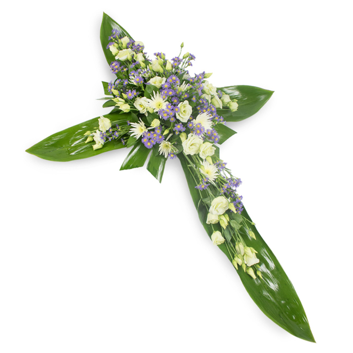 An elegant, reverent cross crafted from broad tropical leaves and soft-hued blooms, presented on a crisp white field and photographed from a slight overhead angle so every detail is visible. The architectural base is composed of large, glossy green leaves - reminiscent of Ti leaves - overlapped to form the cross's arms and central spine; their smooth, veined surfaces create a rich, living foundation. At the intersection and along each arm, clusters of creamy-ivory lisianthus provide a ruffled, almost cloud-like mass of petals, while compact white chrysanthemum or miniature rose heads introduce bright, rounded accents that catch the eye. Scattered among these are sprays of pale lavender limonium or small aster-like flowers, their tiny star shapes offering gentle contrast and a hint of cool colour. Slender green filler and delicate foliage threads are woven through the floral clusters, softening transitions between leaf and flower and adding depth. The overall lighting is soft and even, lending a serene glow to the pale florals and reflecting subtly off the waxy greens; the imagined scent is mild and green, evoking a quiet garden rather than a heavy perfume. Designed as a traditional sympathy arrangement, the piece conveys spiritual calm and enduring remembrance. Locally, such crosses are often chosen for services held at Golders Green Crematorium or for floral tributes delivered to family homes around Golders Green Road, Finchley Road and nearby Hampstead Garden Suburb, where we approach each commission with careful, compassionate craftsmanship.