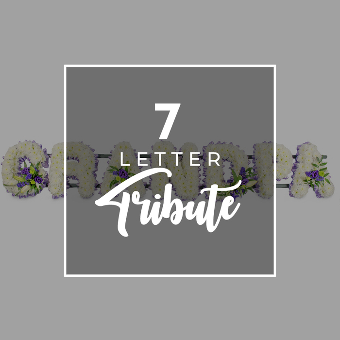 Set against a smooth, mid-grey background that suggests quiet reflection, this image highlights a central dark grey square edged with a slim white border, drawing the eye straight to the text within. The typography is simple yet expressive: a bold white 7 crowns the square, with the word LETTER in smaller, crisp uppercase just below, and Tribute flowing beneath in a sweeping script that softens the overall look. This central panel overlaps a lovingly crafted floral word that reads GRANDMA, a seven-letter funeral tribute that many families in and around Golders Green might choose to honour a cherished grandmother. Each individual letter is shaped from a dense carpet of small white chrysanthemums, their cool, clean petals forming tidy outlines and a soft, almost quilted texture. Nestled among the white blooms are clusters of vivid purple flowers-likely lisianthus or miniature roses-accompanied by glossy green foliage, reminiscent of the greenery you might see walking through nearby Golders Hill Park. On the far left, the circular form of the letter G appears most clearly, its open centre framed in white and touched with purple at one edge, while the following letters-R, A, N, D, M, and the final A-emerge partially from behind the central square, hinting at the full word. The arrangement speaks of meticulous craftsmanship and gentle respect, the sort of carefully composed tribute you might expect from a long-established local florist, designed to rest beside the coffin or at the front of a chapel, offering a soft, dignified message of love and remembrance.