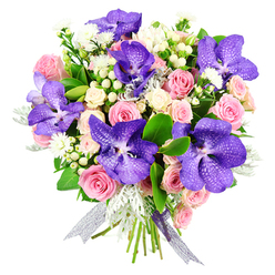 Against a clean white backdrop, this elegant bouquet seems to almost float, its colours and textures carefully balanced by an experienced local florist. Dominating the arrangement are several striking Vanda orchids in rich purple, their petals veined and speckled in indigo tones that feel as intricate as stained glass. These exotic blooms nestle among a generous scattering of soft blush and pastel pink roses, each at a different stage of opening, from tightly furled buds to fully unfurled blooms that reveal delicate, layered hearts. Clusters of creamy white spray roses add a cloud-like softness, filling the spaces between the larger flowers so the bouquet looks lush and abundant from every angle. Intermixed are small, starry white filler flowers and neat clusters of pale hypericum berries, round and waxy like tiny beads, adding gentle texture. Lacing through the design, silvery-green dusty miller leaves offer a cool, velvety contrast to the smooth petals, while glossy dark green foliage anchors the composition and frames the brighter tones. The stems are gathered by hand and tied with a semi-sheer ribbon in a silvery lavender shade, which catches the light with a subtle shimmer and echoes the cool purple of the orchids. The mood is luxurious yet tender, ideal for sending love on an anniversary in Golders Green, marking a special birthday near Temple Fortune, or surprising someone after a walk through nearby Hampstead Heath. It's a bouquet that suggests thoughtful celebration, perfect for same-day delivery when words alone are not quite enough.