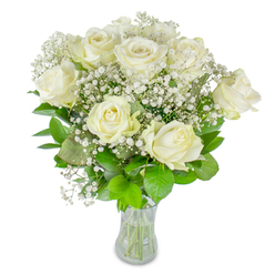 An elegant hand-tied vase arrangement of roughly twelve creamy white roses punctuated by delicate sprays of baby's breath (Gypsophila) is photographed against a clean white background, captured here with the mindful eye of a Golders Green florist. The roses display a range of openness - some petals unfurl wide in plush, velvety spirals while others remain softly cupped - producing a natural rhythm across the bouquet. Between the larger blooms, the baby's breath forms a fine, cloud-like matrix that kisses each rose and softens the silhouette, giving the whole composition an airy, romantic lift. Lush foliage in varied greens - from deep emerald to pale lime - forms a verdant cradle beneath the blossoms, their glossy surfaces catching the light and amplifying the contrast with the pure whites. The arrangement rests in an unadorned clear glass vase that reveals the trimmed stems and water level, underscoring the cut flowers' freshness and the careful craftsmanship behind the placement.

Prepared with the local character of Golders Green in mind, this bouquet evokes quiet celebration and tender remembrance alike: a graceful choice for weddings, anniversaries, or moments of condolence. The scent is subtle, a soft, powdery breath rather than a dominant perfume, suggesting a sunlit conservatory or a calm morning near Golders Green Road. At Flowers Golders Green we arrange blooms to feel personal and composed, balancing texture and tone so the bouquet reads as both confident and consoling - a floral message of enduring affection.
