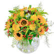 Prepared with the artistry of Golders Green florists, this bouquet radiates the sunny brilliance of a midsummer's day in North London. Sunflowers stand bold and proud at the centre, their dark, velvety hearts ringed by gleaming golden petals that seem to capture the light. Around them, yellow roses unwind in creamy, spiral layers, each bloom like a gentle wish for joy. Bright orange blossoms and clusters of red berries provide playful pops of colour, weaving energy among sprigs of fresh, feathery ferns. The glass vase is clear and rounded, allowing for an artful criss-crossing of stems visible through shimmering water. There's a light, sweet scent, underscored by the freshness of cut greenery-a fragrance that recalls gardens along Hoop Lane and the tranquil paths of Child's Hill Park. This arrangement uplifts and delights, crafted for joyful birthdays, heartfelt thanks, or simply to bring a touch of Golders Green sunshine into any home.