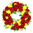 A large, circular red and yellow funeral wreath is set against a bright white background, its colours and shapes clearly defined as if ready for delivery to a quiet chapel in Golders Green. The wreath forms a perfect ring with an open middle, symbolising the ongoing circle of life and memory. Deep red roses provide the central emotional tone, each bloom fully open, with velvety petals layered in neat spirals from tight centres to more relaxed outer edges. The reds range from clear crimson to more somber burgundy, adding both warmth and gravity. Interspersed among the roses are clusters of yellow chrysanthemums, likely spray or button types, whose many fine petals create a soft, cushion-like texture. Their cheerful yellow hue introduces a sense of gentle lightness, suggesting hope and a celebration of life even in moments of loss. Throughout the wreath, rich green foliage weaves in and out of the blossoms: there are broad, glossy leaves that form a solid, supportive base and smaller, understated grey-green leaves reminiscent of eucalyptus, which lend a slightly silvery, calming touch. The greenery fills the spaces without disturbing the symmetry, making the wreath appear generous and complete from every angle. Under clear, even lighting, the details of each flower and leaf stand out-no shadows distract from the craftsmanship. It feels like the kind of carefully considered tribute a family might choose for a funeral service at Golders Green Crematorium, a memorial near Childs Hill, or a graveside farewell in the wider NW11 area, expressing deep affection, respect, and remembrance through colour and form.