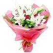 A luxurious hand-tied bouquet of white Oriental lilies and deep red roses is shown standing proudly against a pure white background, evoking the polished yet welcoming charm of a Golders Green florist's counter. The lilies form the heart of the composition: large, trumpet-shaped blooms with smooth, ivory-white petals that curve outward in generous arcs, revealing dark reddish-brown stamens dusted with pollen. Some lilies are fully open and expansive, while several buds remain closed or just beginning to split at the tips, their pale green casings holding the promise of more blossoms to come. Weaving through these lilies are red roses in various bud stages, their velvety petals tightly layered, creating rich, rounded focal points of colour that suggest romance, affection, and deep appreciation. Surrounding the blooms, lush foliage provides a strong backdrop, with broad, dark green leaves adding structure and slender, spiky strands of greenery lending a sense of movement, as if the bouquet had just been gathered from a garden near Golders Hill Park. The flowers are embraced by a billowing wrap of bright pink, translucent cellophane that swirls around the stems in glossy folds. Light glints off its surface, giving the arrangement a celebratory, almost gift-wrapped feel perfect for birthdays, anniversaries, or thank-you gestures. At the base, a slim lime green ribbon is tied neatly around the stems, its satin sheen and citrus-bright colour offering a playful contrast to the pink wrap and dark foliage. Overall, the bouquet feels both elegant and joyful, a striking choice for same-day flower delivery to friends, family, or colleagues across Golders Green.