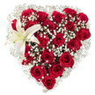 Set against a clean white backdrop, this lush heart-shaped arrangement reads like a carefully composed love letter in blooms. Dozens of deep, crimson red roses form the dense heart, their velvety petals layered and catching a soft, even light so that some blooms appear almost satin while others show the darker, tender shadows of inner petals. Between and around the roses, clouds of tiny white baby's breath (Gypsophila) drift like gentle mist, their star-like florets softening edges and creating an airy halo that lets the passionate reds breathe. Nestled into the upper-left curve of the heart is a single, sculptural white lily: its broad, pristine petals unfold with a subtle cream wash toward the throat and display warm yellow stamens that punctuate the composition with a quiet brightness. The contrasts of texture are deliberate - the plush, rounded roses, the feathery gypsophila, and the smooth waxiness of the lily each invite a different tactile imagination and a layered scent profile, from the heady rose perfume to the fresher, green note of the lily. The arrangement feels intentional and expertly balanced, the heart silhouette clean and precise without appearing rigid. Soft studio lighting isolates the bouquet from its white background, making the reds pop and the whites read as pure, almost luminous points of calm. Perfect for a romantic occasion, an anniversary, or a heartfelt tribute, this floral heart speaks of passion tempered by tenderness and of craftsmanship that honours both form and feeling, a classic presentation that holds up beautifully in photographs or as a focal display at an intimate gathering in Golders Green.