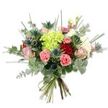 A richly textured, hand-tied bouquet sits against a crisp white backdrop, its lively colours and varied forms described as if lifted from an early summer walk through Golders Hill Park. At the heart is a voluminous cluster of lime-green hydrangea, the tiny, cloud-like petals packed together to give a soft, billowing centre that catches light like a small green lantern. Around that central bloom, deep, velvety red roses bring a classic note of passion while blush pink and creamy ivory roses unfold with gentle, romantic curves; their softer petals contrast with the hydrangea's compact mass. Scattered through the composition, coral-pink carnations show their ruffled edges and cheerful warmth, adding plush texture and movement. Cool, architectural Eryngium thistles - metallic blue-grey and spiky, with star-like crowns - introduce a modern, slightly wild accent that balances the softness of the roses. The bouquet is generously filled with mixed greenery: silvery-green eucalyptus rounds and slender cascading leaves give a muted, aromatic backdrop, while long, upright blades of grass or thin green foliage lift the silhouette and create airy, dynamic lines. The stems are gathered into a neat hand-tied bundle and secured with a natural-coloured twine or ribbon, the trimmed green stems visible at the base and suggesting fresh cutting and careful craftsmanship. In soft daylight the eucalyptus offers a subtle, citrusy scent and the mix of textures - plush hydrangea, velvety roses, frilly carnations, and spiky thistles - reads as both sophisticated and joyful. This arrangement feels appropriate for birthdays, anniversaries or simply to bring a quiet moment of celebration to a home in Golders Green or nearby Finchley Road.