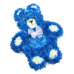 A carefully crafted floral teddy bear fills the frame against a crisp white background, its form both playful and deeply moving. The bear is built from countless small royal blue blossoms, most likely chrysanthemums, which are placed so close together that they create a perfectly even coat, mimicking the texture of plush fur. The blue is strong and velvety, drawing the eye across the rounded head, softly curved tummy, and open arms and legs that stretch outward as if offering a gentle embrace. Soft cream and pale yellow flowers mark out the inner ears, the rounded snout, and four distinct paw pads, their lighter colour gently lifting the design and giving the bear a touch of sweetness and innocence. Two glassy, dark amber eyes are set slightly above the muzzle, and a neat black triangle nose sits at the centre, with a delicate curved line beneath to suggest a quiet, reassuring smile. Around the neck, a fine white organza or mesh bow is tied neatly, its translucent loops adding a delicate, almost angelic finish. The bear lies slightly on an angle, lending a natural, relaxed feel, while the white background allows every detail to stand out clearly, from individual petals to the soft curves of the design. This floral sculpture feels like a tender companion piece for a funeral or memorial, especially for a baby boy or child, and would be at home in a peaceful chapel near Golders Green station or in a family living room as a private remembrance. It communicates love, serenity, and the gentle solace that only flowers can bring.